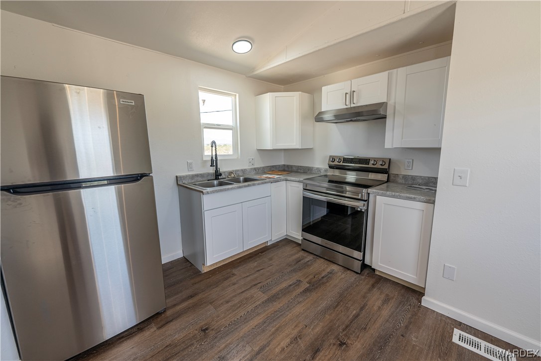 2337 South Canelo Road Golden Valley, AZ 86413 - Photo 3 of 30 a kitchen with stainless steel appliances a stove a sink and a refrigerator