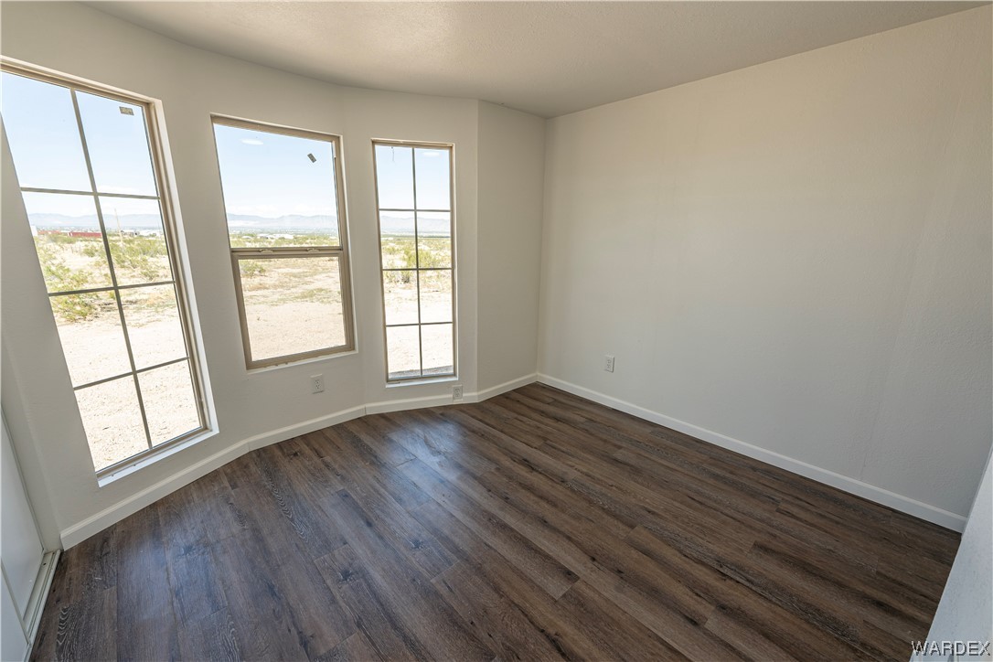2337 South Canelo Road Golden Valley, AZ 86413 - Photo 7 of 30 an empty room with wooden floor and windows
