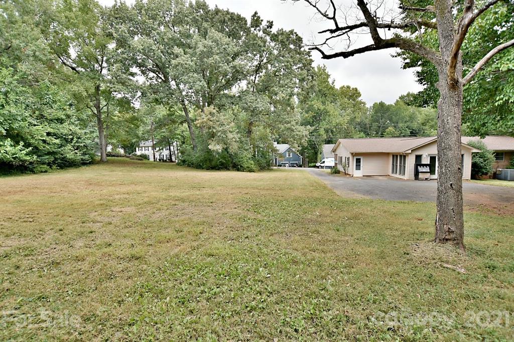 a view of an house with backyard space and balcony