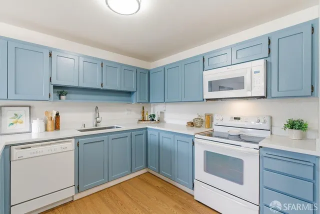 a kitchen with a sink window and cabinets