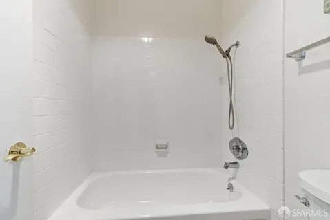 a bath tub sitting next to a white toilet