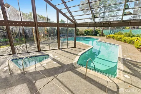 a view of a swimming pool with an outdoor space and seating area