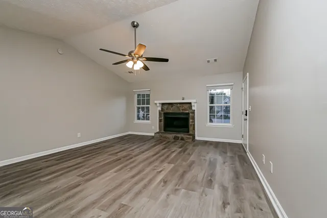 wooden floor in an empty room with a fireplace