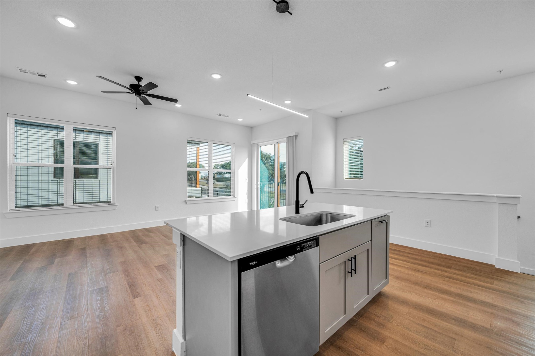 1601-622 Mustang Drive Marble Falls, TX 78654 - Photo 11 of 16 a kitchen with a sink dishwasher and white cabinets with wooden floor