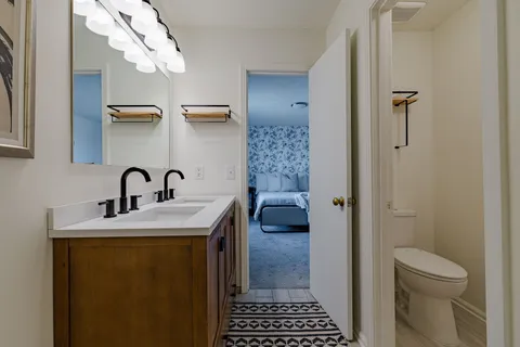 a en suite bathroom with a sink a toilet and shower