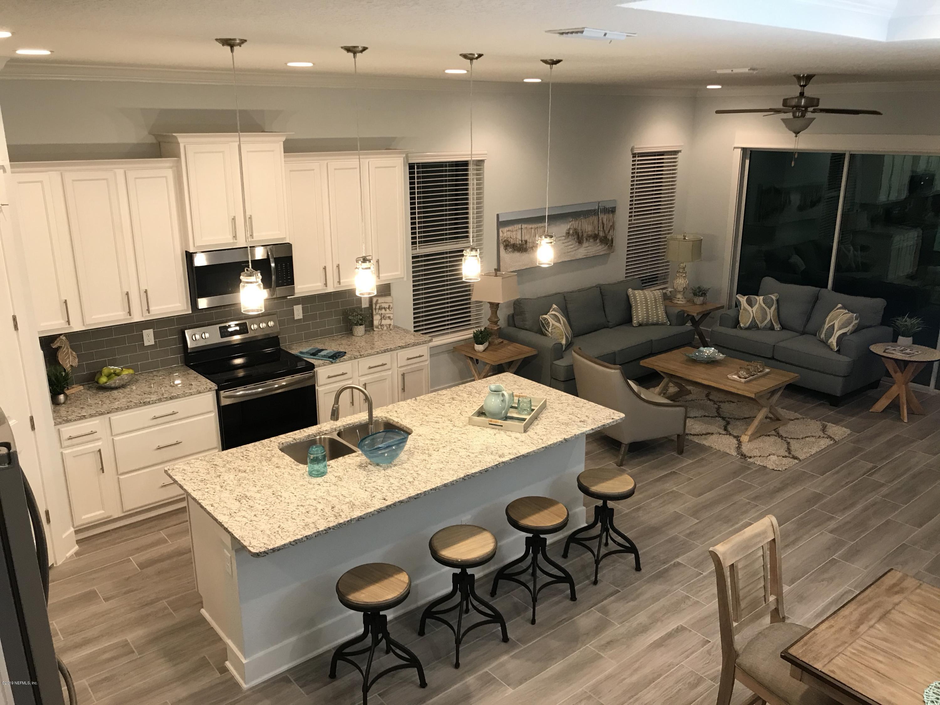 1709 Riley Street Jacksonville Beach, FL 32250 - Photo 11 of 42 a kitchen with a stove a sink dishwasher a dining table and chairs with wooden floor