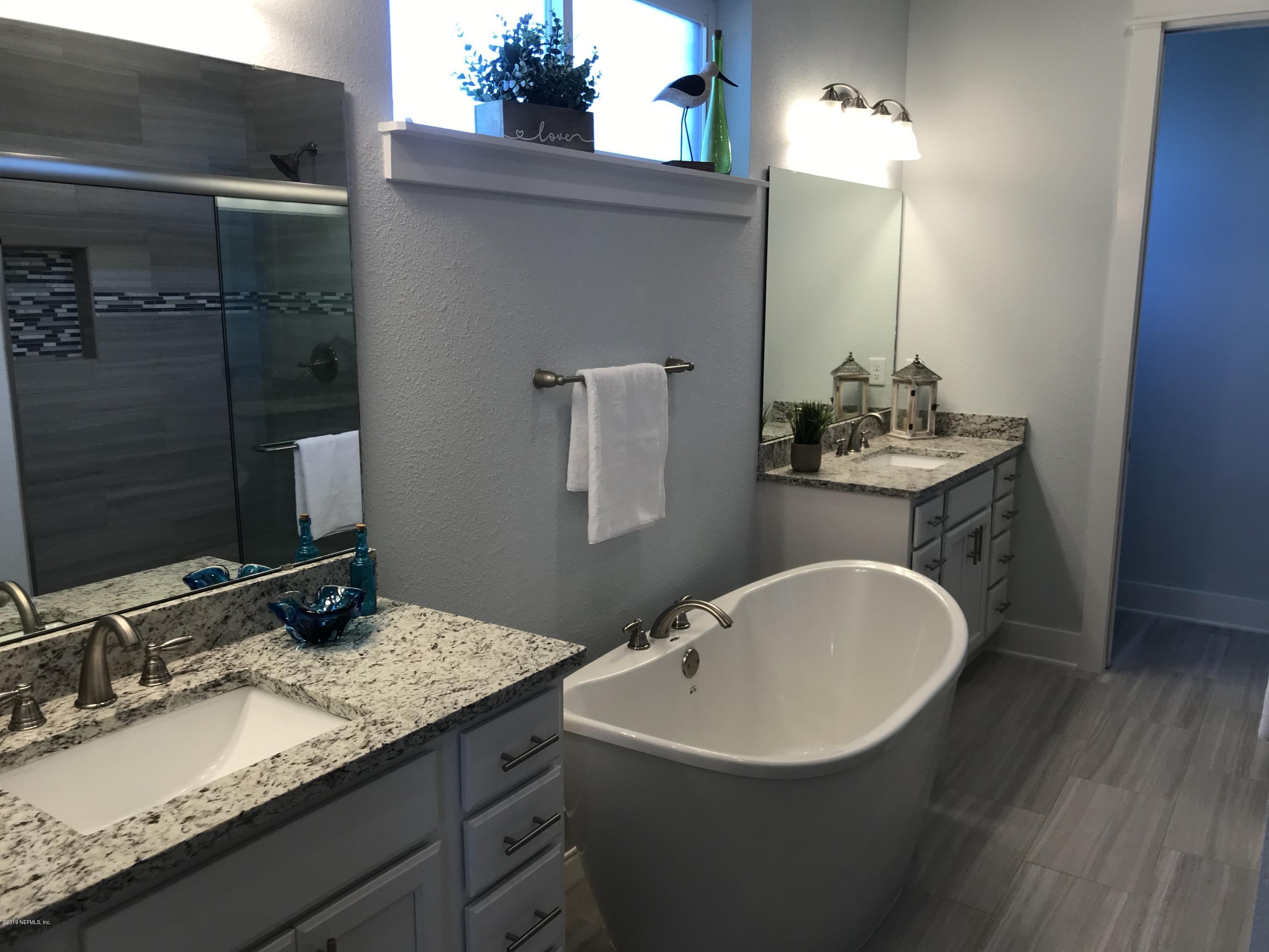 1709 Riley Street Jacksonville Beach, FL 32250 - Photo 21 of 42 a bathroom with a granite countertop sink a mirror and vanity