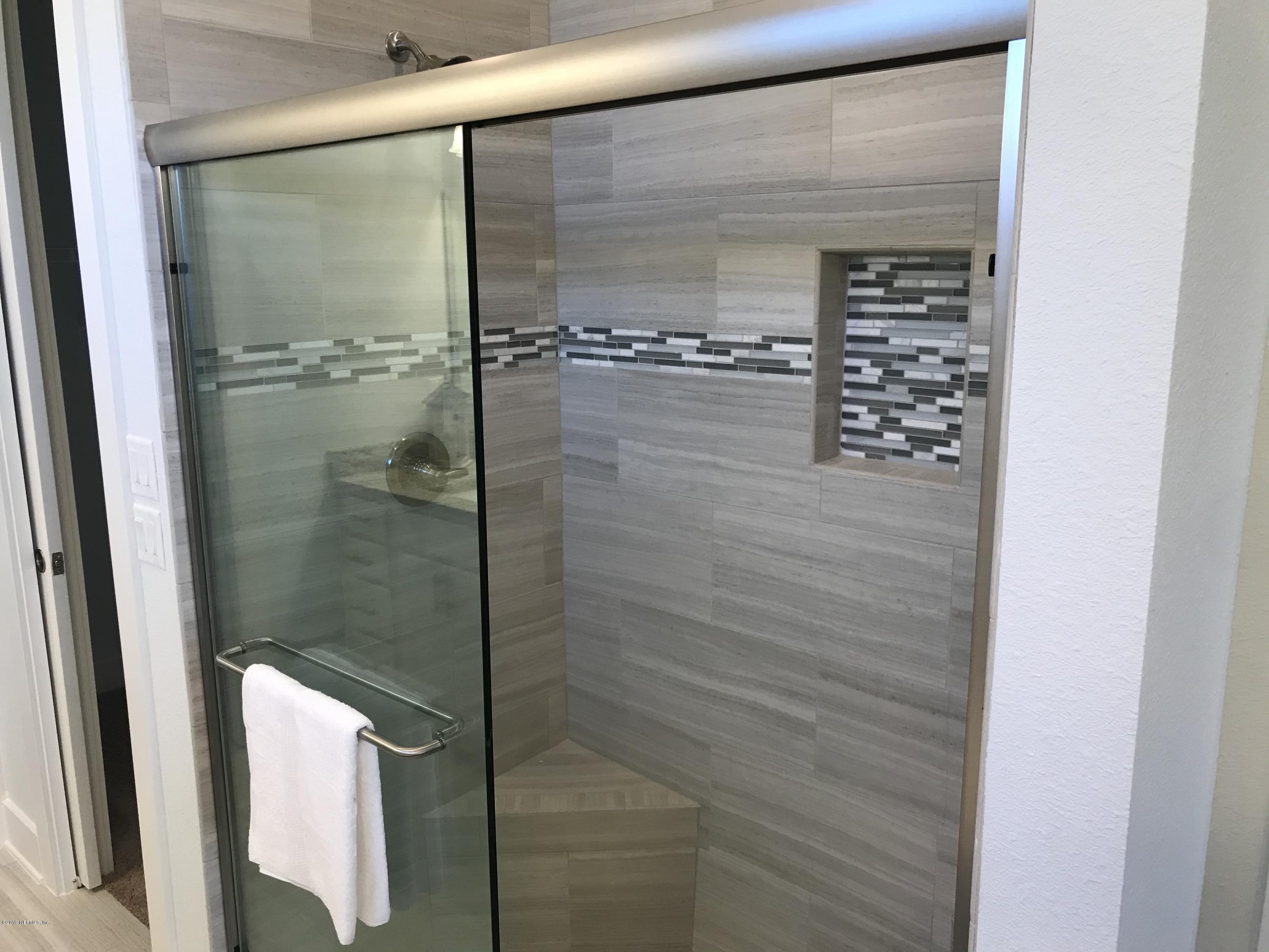 1709 Riley Street Jacksonville Beach, FL 32250 - Photo 22 of 42 a bathroom with a glass shower door
