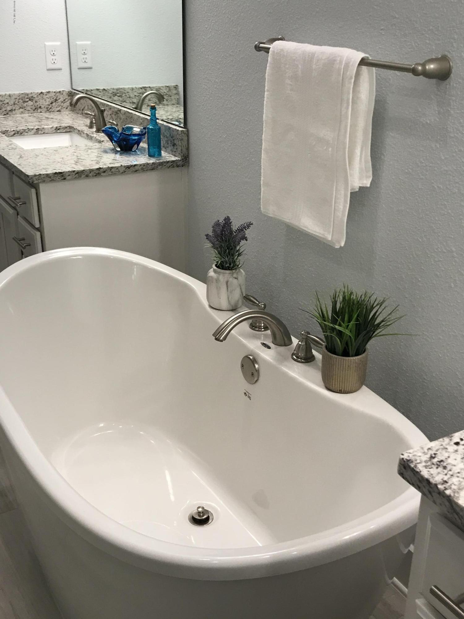 1709 Riley Street Jacksonville Beach, FL 32250 - Photo 23 of 42 a white bath tub sitting next to a white sink