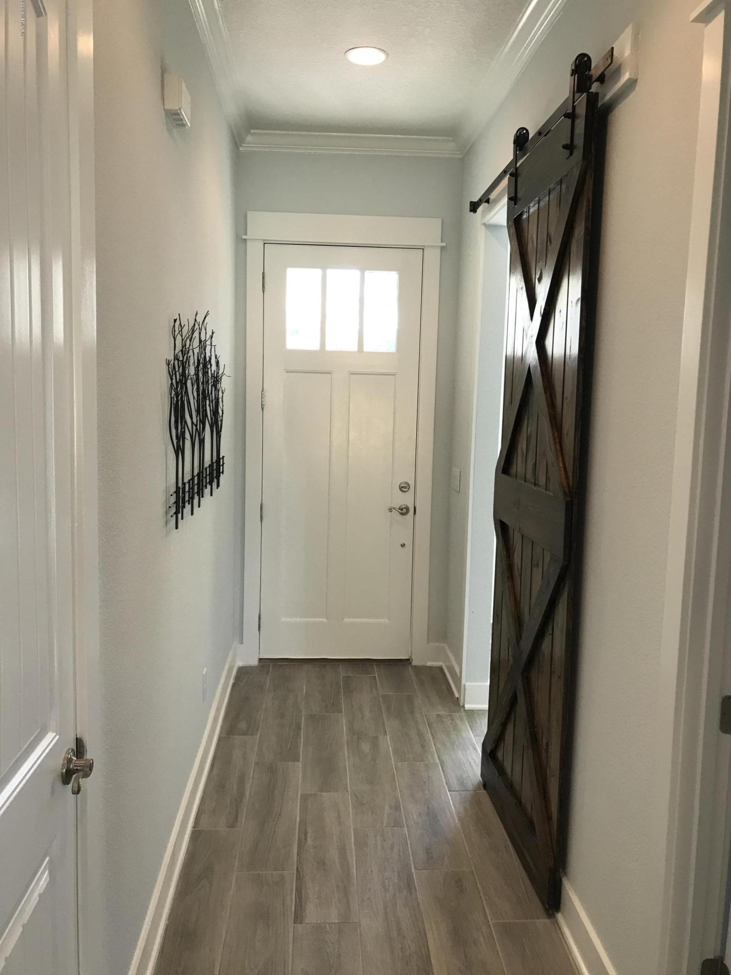 1709 Riley Street Jacksonville Beach, FL 32250 - Photo 25 of 42 a view of a hallway with wooden floor and stairs