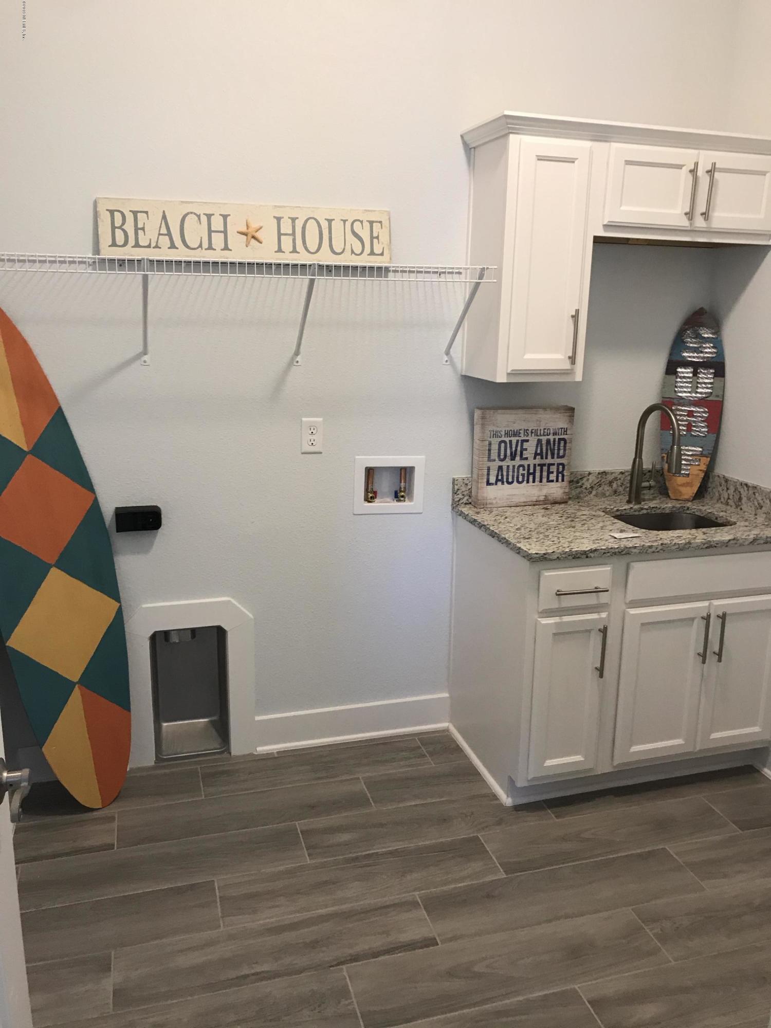 1709 Riley Street Jacksonville Beach, FL 32250 - Photo 30 of 42 a kitchen with cabinets and wooden floor