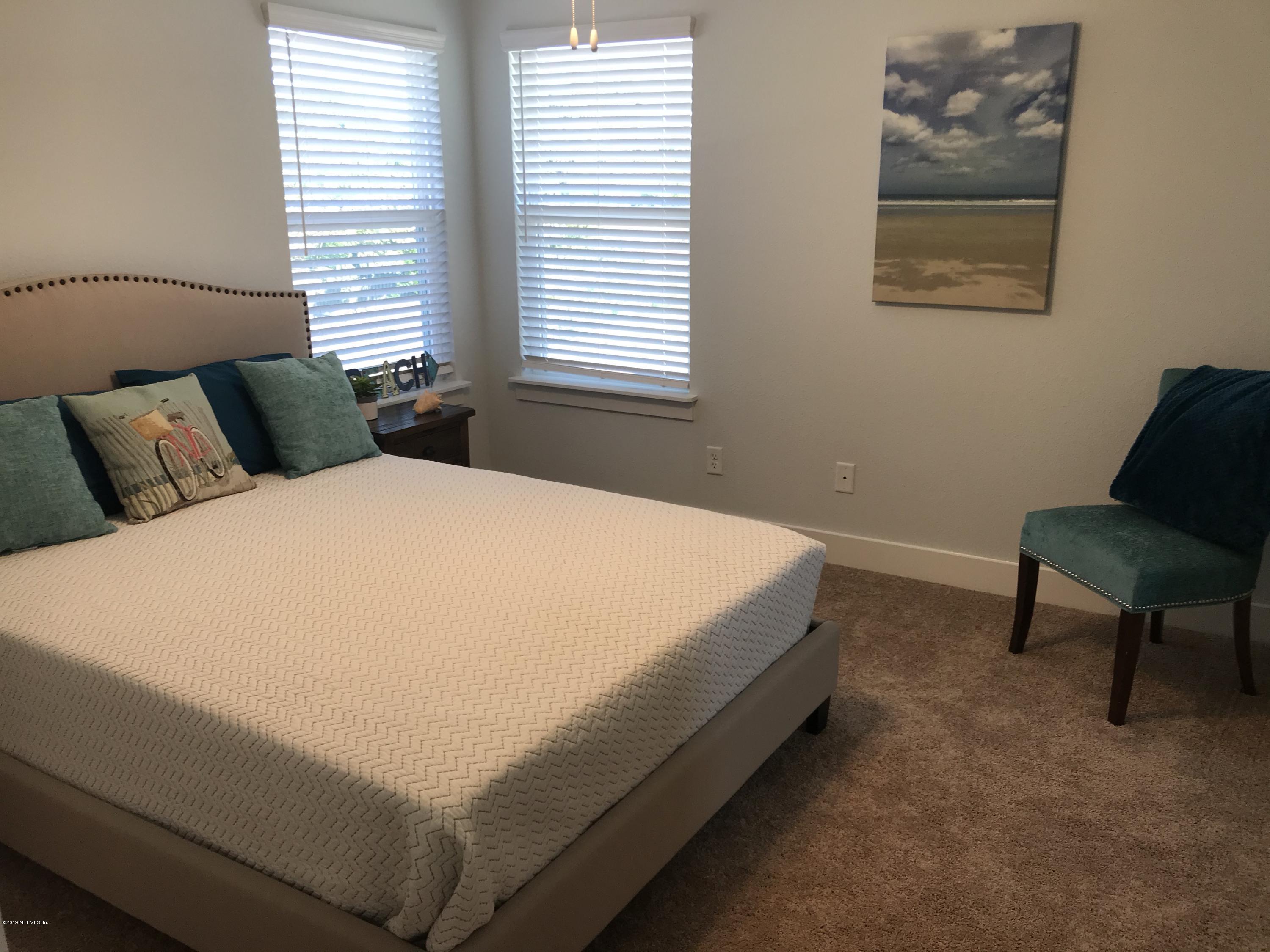 1709 Riley Street Jacksonville Beach, FL 32250 - Photo 39 of 42 a bed sitting in a bedroom next to a window