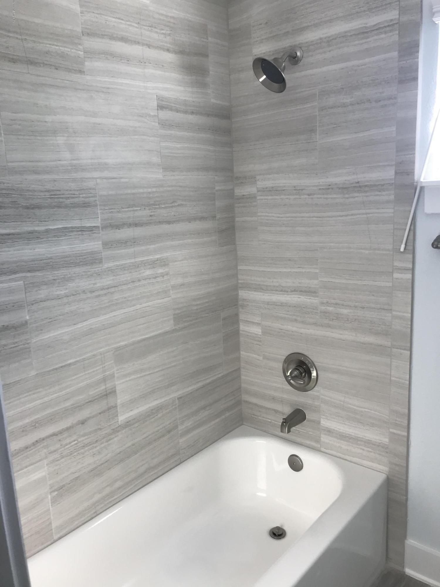 1709 Riley Street Jacksonville Beach, FL 32250 - Photo 41 of 42 a bathroom with a white bath tub