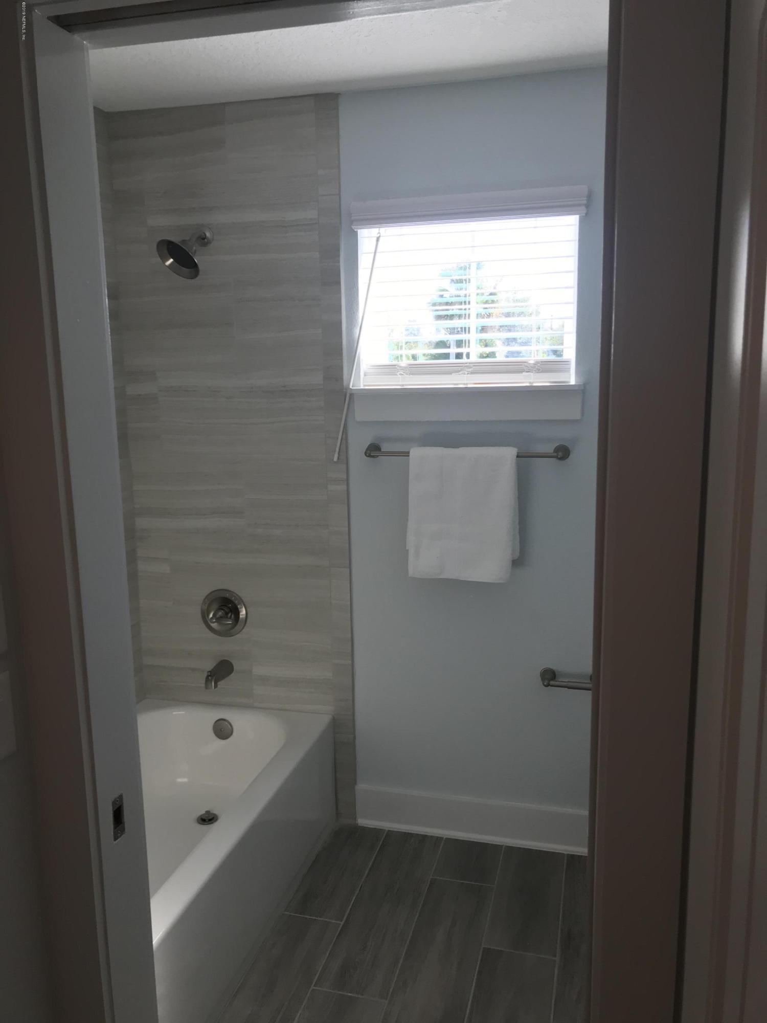 1709 Riley Street Jacksonville Beach, FL 32250 - Photo 42 of 42 a bathroom with a bathtub and a window