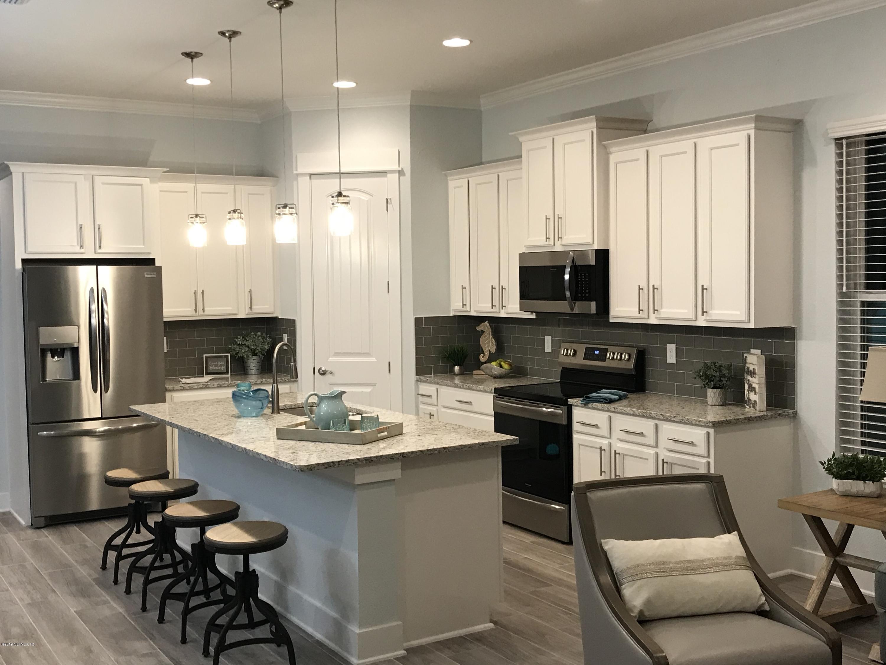 1709 Riley Street Jacksonville Beach, FL 32250 - Photo 7 of 42 a kitchen with a refrigerator a stove a sink and chairs