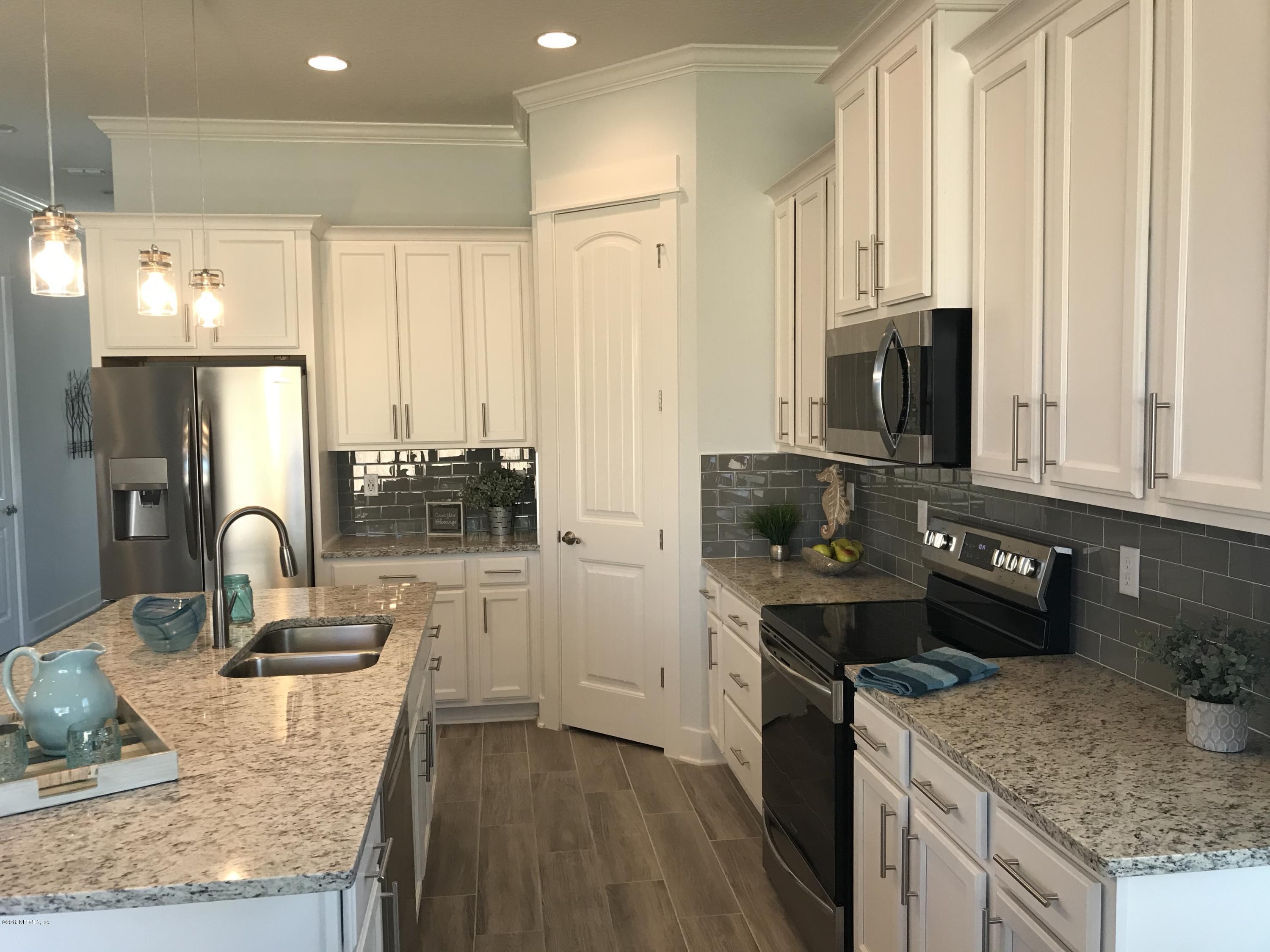 1709 Riley Street Jacksonville Beach, FL 32250 - Photo 8 of 42 a kitchen with stainless steel appliances granite countertop a stove refrigerator sink and cabinets
