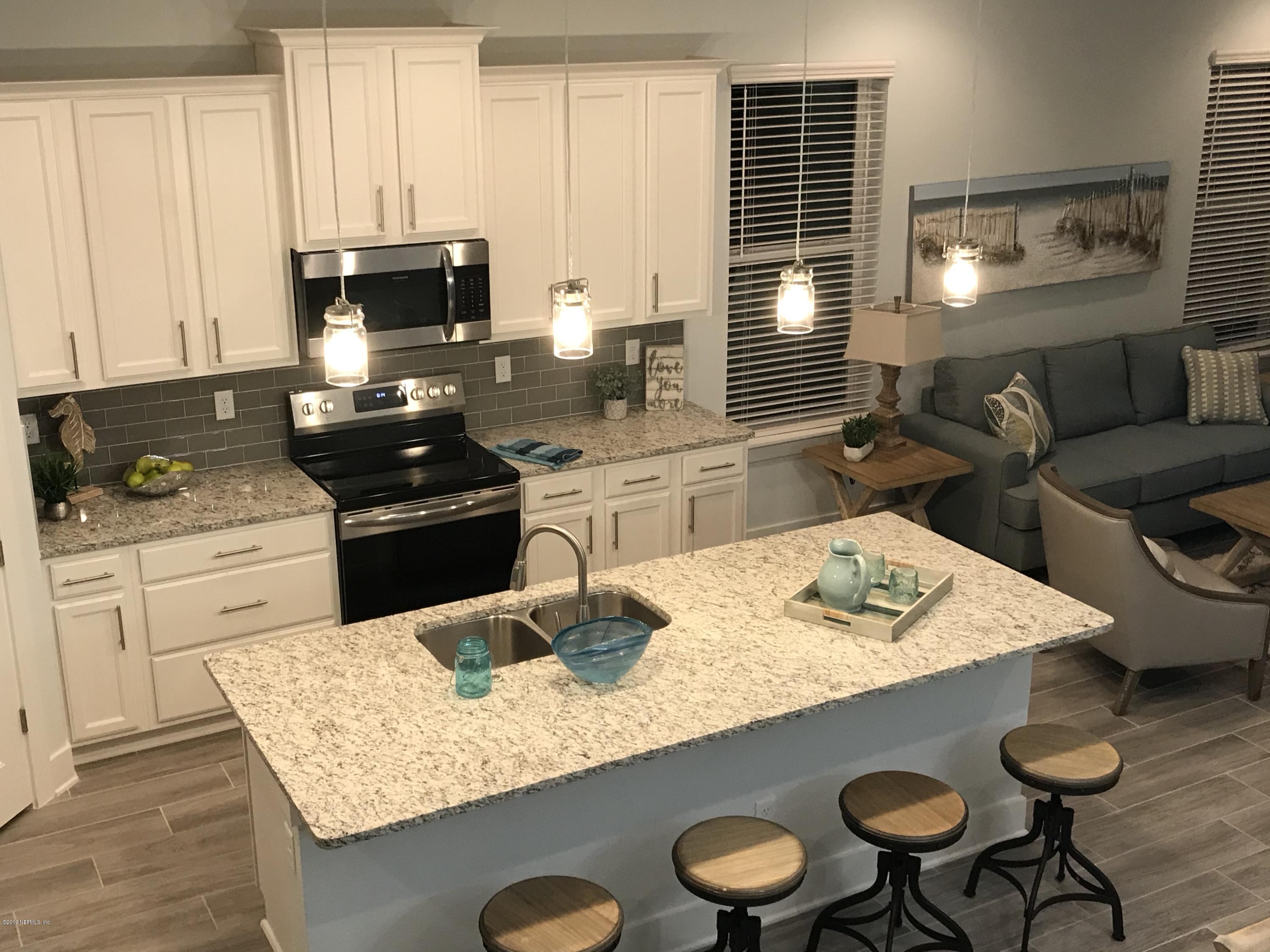 1709 Riley Street Jacksonville Beach, FL 32250 - Photo 9 of 42 a kitchen with a stove a sink dining table and chairs