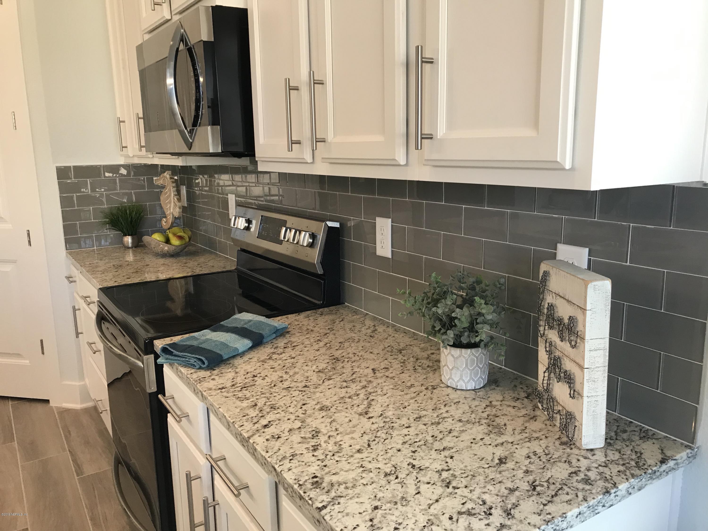 1709 Riley Street Jacksonville Beach, FL 32250 - Photo 10 of 42 a kitchen with a stove and a sink