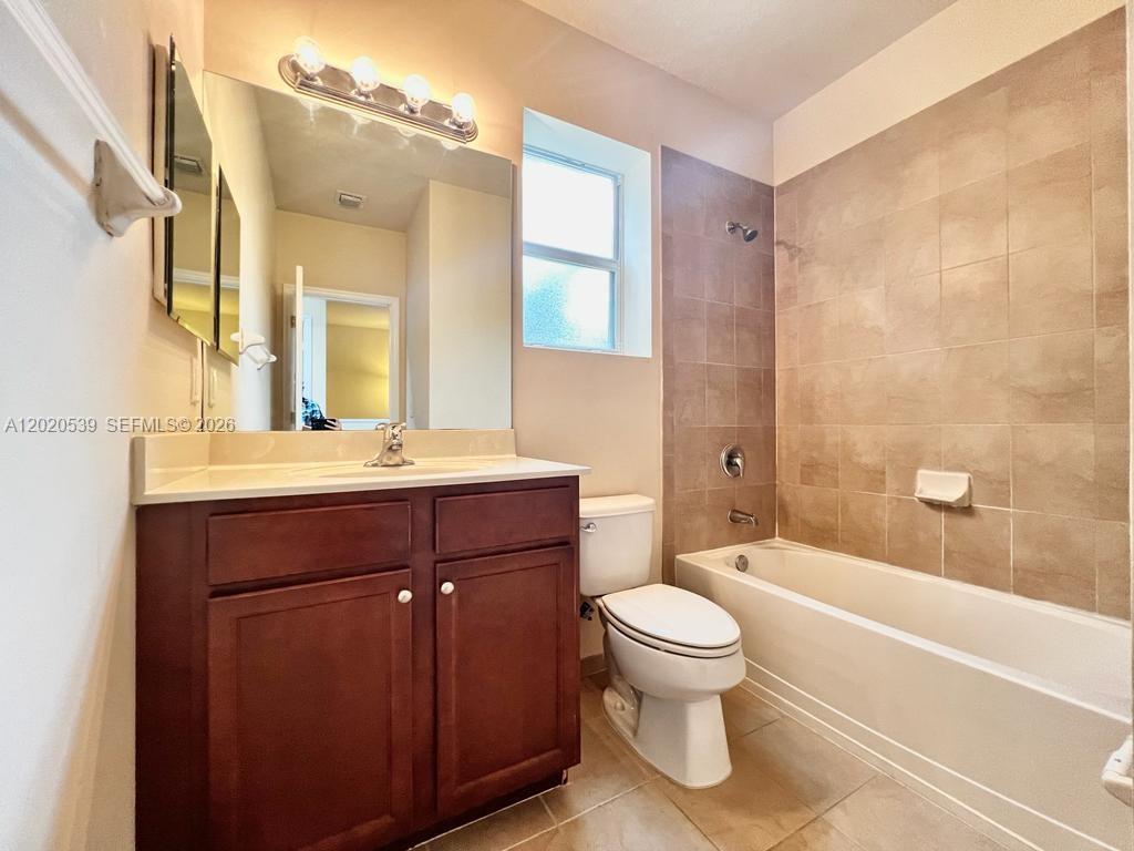 17001 Southwest 96th Street Miami, FL 33196 - Photo 12 of 23 a bathroom with a sink a toilet and a large mirror