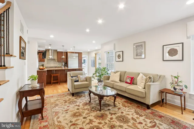 a living room with furniture a fireplace and a table