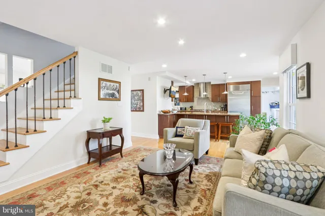 a living room with furniture and kitchen view