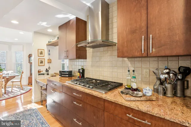 a kitchen with kitchen island granite countertop a sink a counter and cabinets