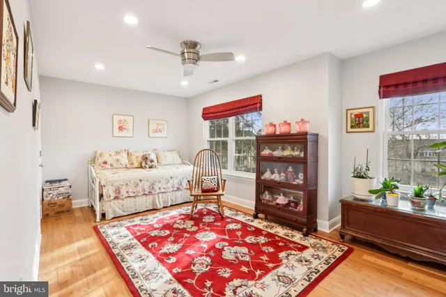 a spacious bedroom with a bed and a chandelier