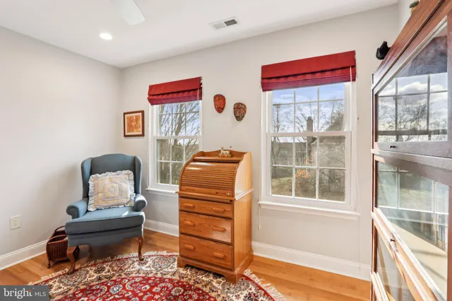 a view of a big house with a big yard and large trees