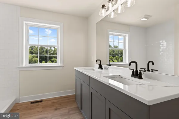 an empty room with window and wooden floor