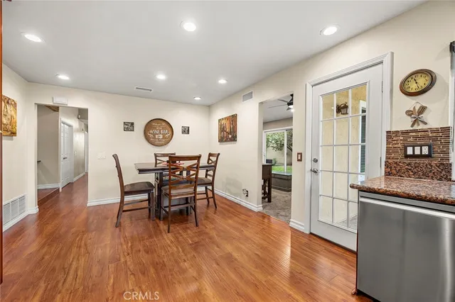 a view of a a dining room with furniture window and wooden floor
