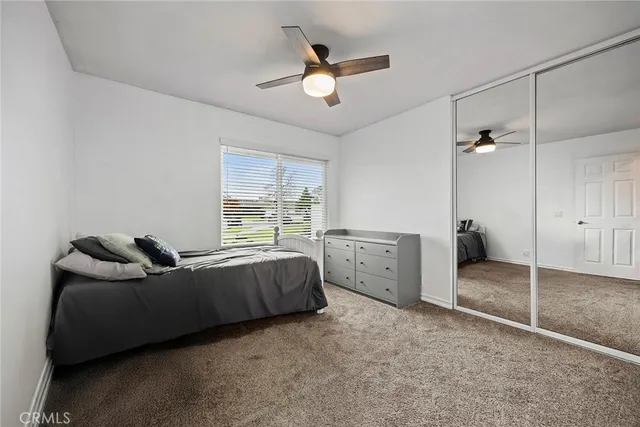 a living room with furniture and a ceiling fan