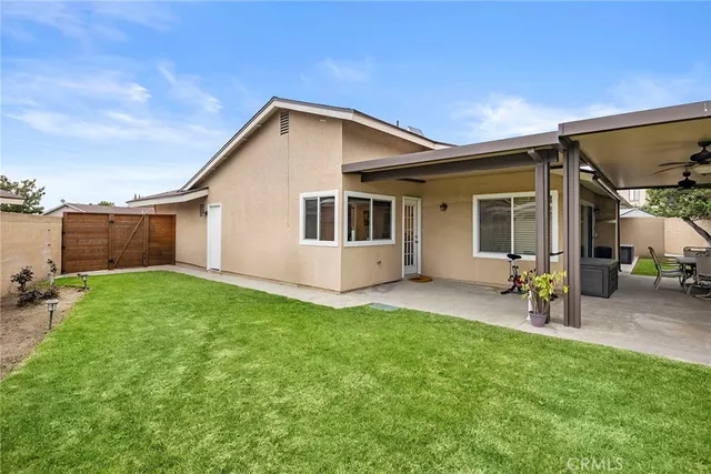 a view of a house with a yard and sitting area