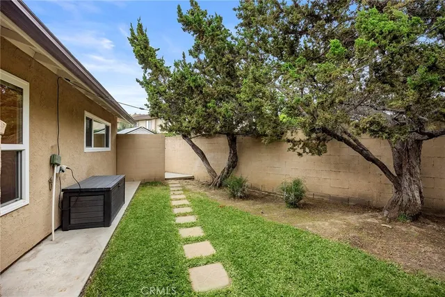 a backyard of a house with table and chairs
