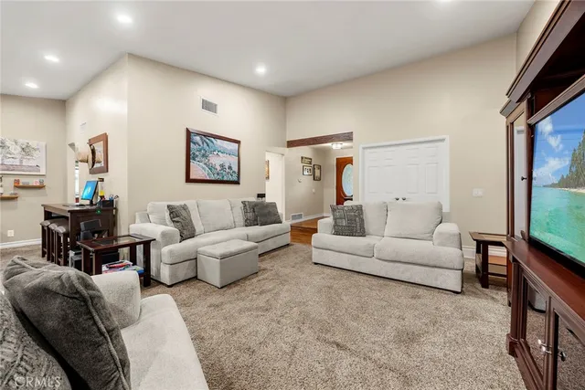 a living room with furniture wooden floor and a flat screen tv