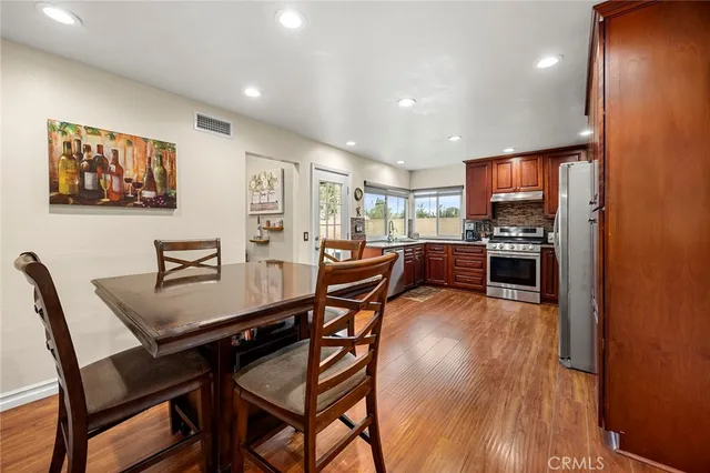 a dining room with furniture and wooden floor