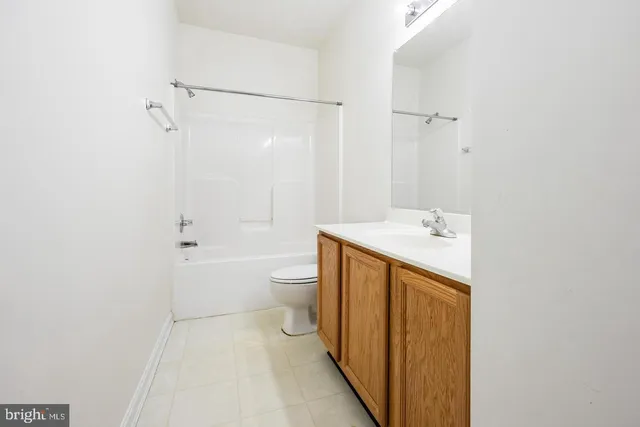 a white toilet sitting next to a bath tub