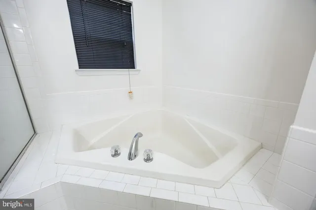 a view of a hallway with wooden floor and fence