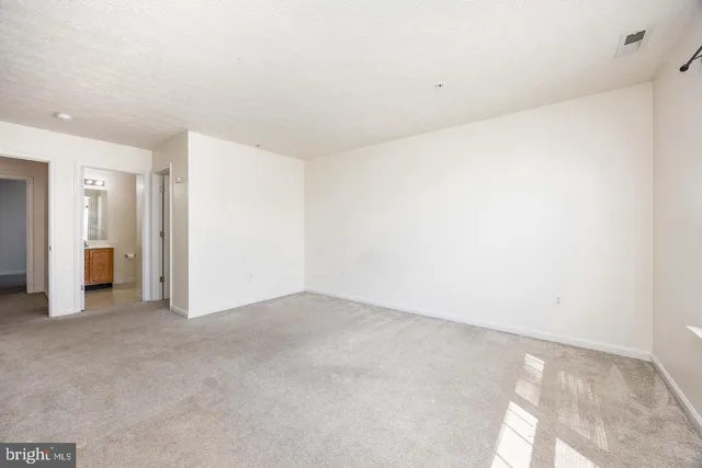 a view of a house with a big yard and large trees