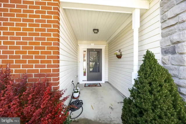 a view of a hallway with wooden floor and entryway