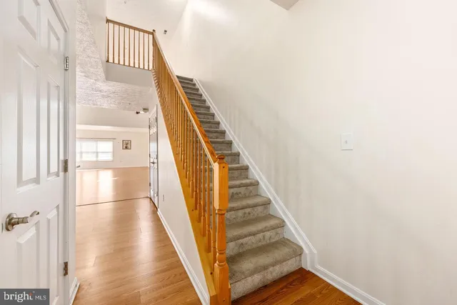 a view of a hallway with wooden floor and entryway