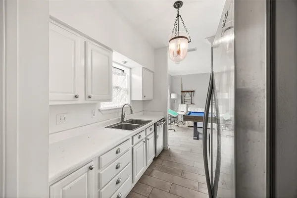 a room with pool table and windows
