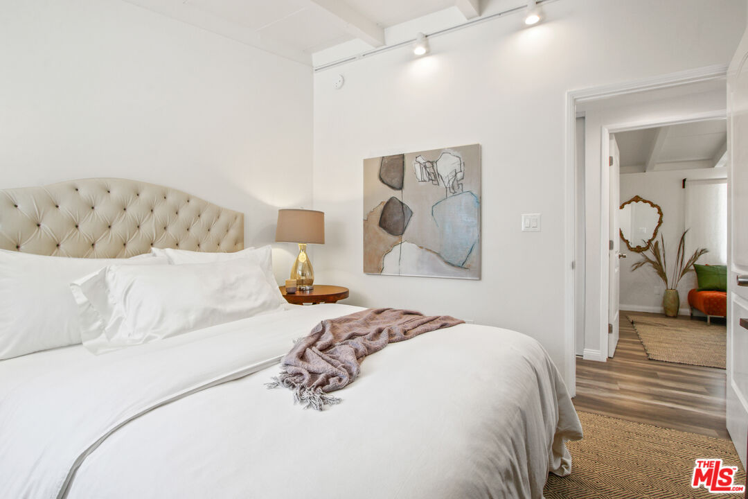 6440 Rhea Avenue Reseda, CA 91335 - Photo 19 of 22 a bedroom with a large bed and a chandelier