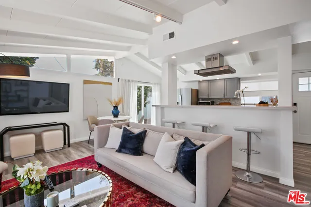a living room with furniture and flat screen tv