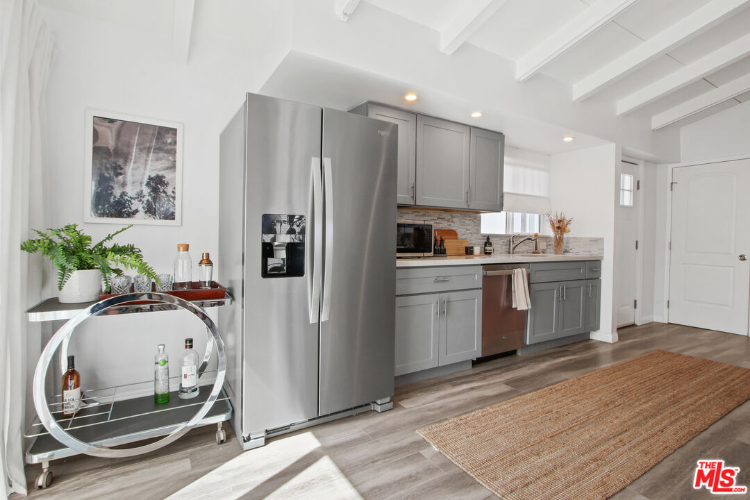 6440 Rhea Avenue Reseda, CA 91335 - Photo 6 of 22 a kitchen with white cabinets and appliances