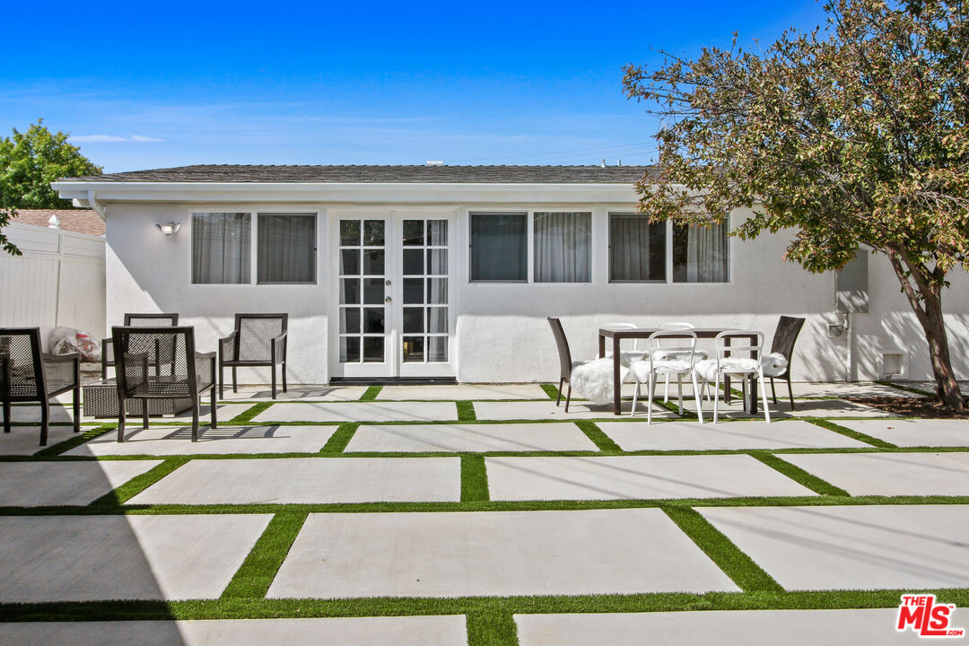 6440 Rhea Avenue Reseda, CA 91335 - Photo 7 of 22 a view of a patio with couches and table and chairs with wooden floor and fence