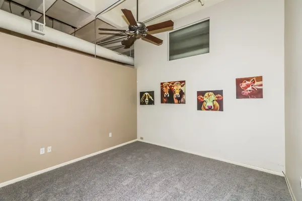 a view of a hallway with a ceiling fan