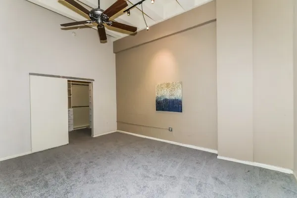 a view of an empty room with a fan