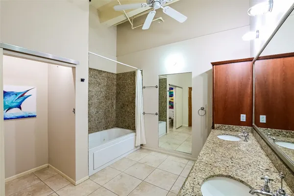 a bathroom with a tub and shower