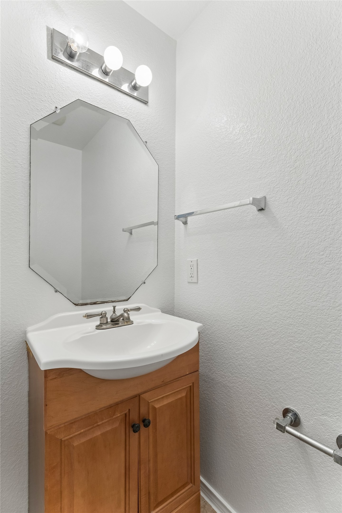 2372 Paradise Ridge Drive Round Rock, TX 78665 - Photo 23 of 40 A well-lit powder room features a functional vanity with a sleek mirror.
