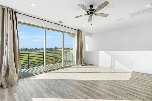 a view of a livingroom with a ceiling fan and window